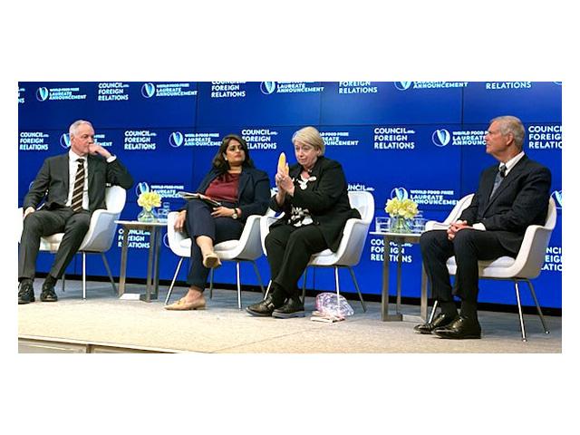 On a panel discussing "Food Security in a Strategic Age," Sharon Burke holds a corn cob that is produced today as an example of a future shrunken cob if agricultural research does not continue to provide innovations. Burke, chief engagement officer at the International Maize and Wheat Improvement Center, known by its Spanish acronym CIMMYT in Mexico, where Norman Borlaug conducted his wheat research that led to the Green Revolution. (Photo by Jerry Hagstrom/The Hagstrom Report)